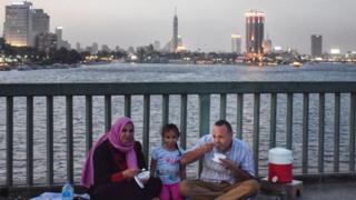 A family eating on a bridge over the Nile River in Cairo Egypt