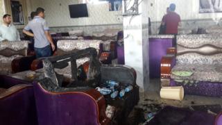 People inspect damage after attack on al-Furat cafe in Balad, Iraq (13 May 2016)