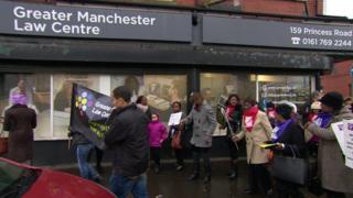 People march past the Greater Manchester Law Centre