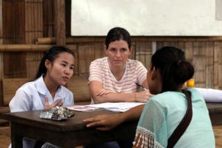 Gracia Fellmeth and a colleague talks to a young woman in Mae La