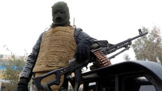 A member of Iraqi pro-government forces stands guard in the city of Falluja, Anbar province, 29 December 2016