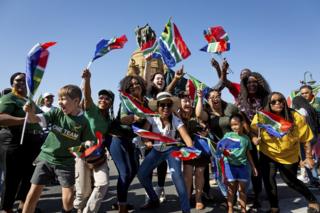 South African rugby supporters cheer for their Rugby World Cup winning national team, the Springboks, in Pretoria