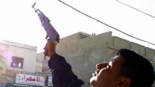 An Iraqi shoots celebratory gunfire in the southern city of Nasiriyah (14 December 2003)