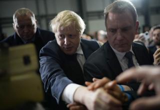 in_pictures Boris Johnson shakes hands with supporters after a speech at a factory on December 10