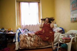 María Isabel, a resident of Casa Xochiquetzal, in her bedroom