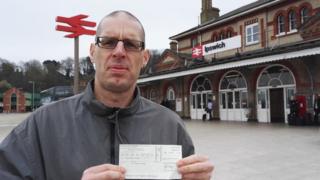 Seph Pochin holding his cheque