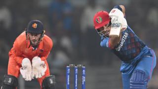Rahmat Shah (right) of Afghanistan plays a shot as Netherlands captain Scott Edwards (left) keeps wicket