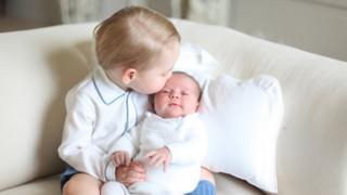 Prince George kisses his new baby sister Princess Charlotte.