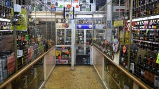 A interior of a liquor store displaying bottles and cans with price tags is pictured in Glasgow on November 1