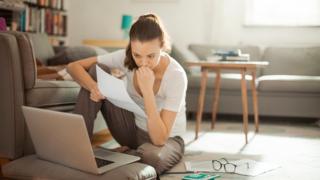 woman looking at bills