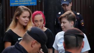 Intruders affiliated to anti-Kremlin punk band Pussy Riot, Veronika Nikulshina, Olga Kurachyova and Olga Pakhtusova, who ran onto the pitch during the World Cup final between France and Croatia, walk out of a detention centre
