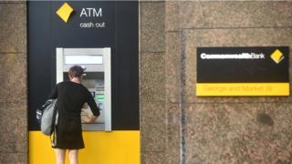 A woman using a Commonwealth Bank ATM