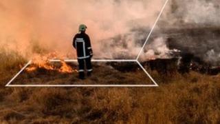 Firefighter at fire with what3words grid showing location name