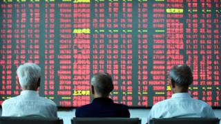Investors stare at trading screen