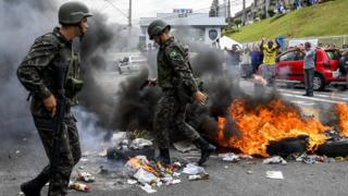 Militares apagam barreira de fogo feita por manifestantes