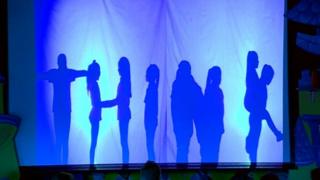 Silhouetted children form the word "Think"