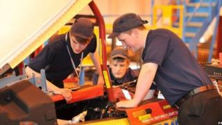 apprentices with motor car