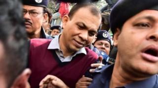 Bangladeshi Commander in the Rapid Action Battalion (RAB) Tarek Sayeed (centre) is escorted by police at Narayanganj court in Narayanganj on January 16, 2017.