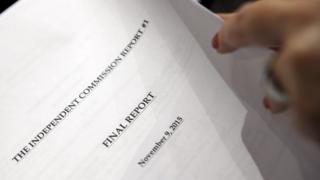 A reporter holds the report of the Commission's Report surrounding allegations of doping prior a press conference, in Geneva, Switzerland (09 November 2015)