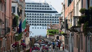 Cruise ship MSC Magnifica is seen from one of the canals leading into the Venice Lagoon on 9 June 2019 in Venice.