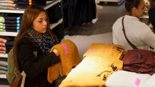 Women shoppers in a clothes store, Oct 2015