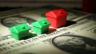 Monopoly houses on dollar bills