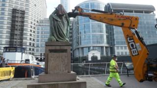 Workmen taking down Robert Milligan statue