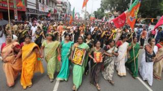 Women with flags walking on a street protest