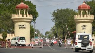 Indian drivers enter through a gate at an ammunition depot where a fire broke out in Pulgaon some 100kms from Nagpur on May 31, 2016.