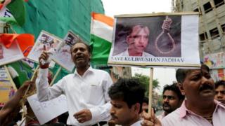 National Congress activists hold photographs of Indian national, Kulbhushan Jadhav, and placards against Prime Minister Narendra Modi in Calcutta, Eastern India 24 April 2017,