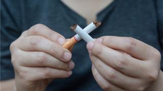 boy breaking a cigarette