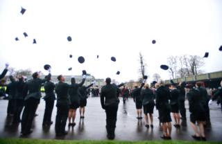 Officers throwing hats