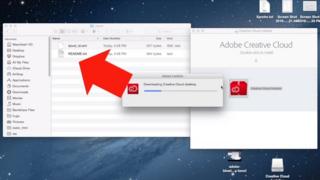 A Mac desktop with Creative Cloud being installed