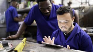 Man looking at a tablet at work