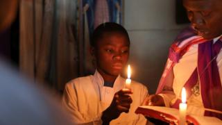 Worshipers pray during Easter prayers at a Legio Maria African Mission Church in Kibera slum in Nairobi Kenya, April 1, 2018.
