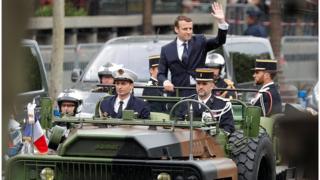 Президент Макрон приветствует толпу на Елисейских полях