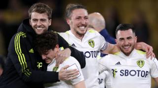 Leeds players celebrate victory at Wolves