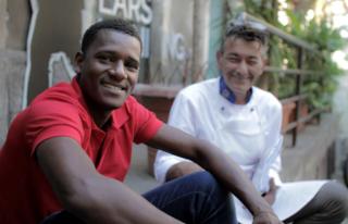 Yahya and Salvo Baltico sit outside 11Eleven restaurant in Sicily