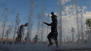 Children play in a New York water feature