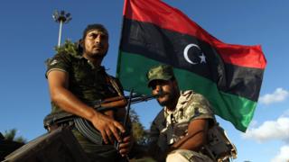 Libyan troops loyal to Khalifa Haftar sit on an APC in Benghazi, August 2015