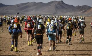 People compete in the fourth stage of the 34th edition of the Marathon des Sables between Jebel El Mraier and Rich Mbirika in the southern Moroccan Sahara desert, on Wednesday 10 April 2019