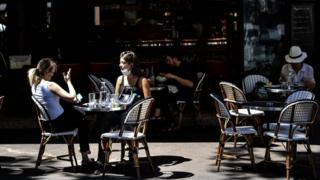 Customers take drinks at the terrace of a cafe-restaurant in Paris on June 2, 2020