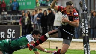 Dragons' Nick Scott is pushed into touch by Tiernan O'Halloran of Connacht