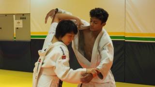Yuko Fujii coaching a boy