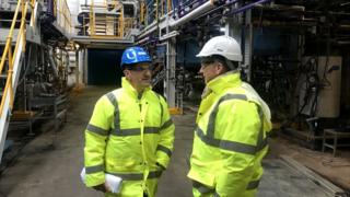 2 men in high vis and hard hats at chemical factory