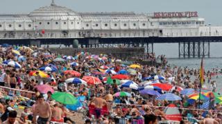 People enjoy the hot weather at Brighton beach, amid the coronavirus disease (COVID-19) outbreak, in Brighton, Britain, August 8, 2020