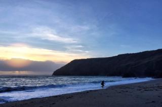 Person running away from waves