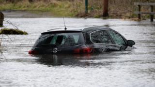 A car partially submerged in floodwater