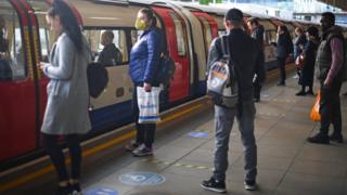 Passengers at Canning Town underground station in east London