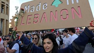 Lebanese demonstrators take part in a civilian Independence Day parade in Beirut's Martyr Square on November 22, 2019,